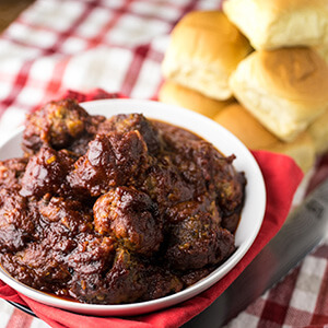 These slow cooker BBQ meatballs are so easy to make and they're true comfort food. They are perfect to eat on their own or on sliders! | recipe from Chattavore.com