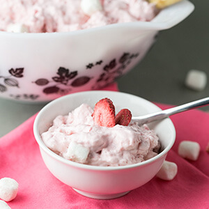 Who doesn't love strawberry fluff? This version is made with fresh strawberries, fresh whipped cream, cream cheese, and marshmallows. | Recipe from Chattavore.com