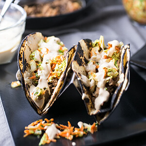 These Asian pork tacos are made with tender pork shoulder & light, delicious slaw & come together so quickly in the pressure cooker or Instant Pot! | recipe from Chattavore.com