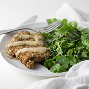 Coated in crunchy sesame sticks and baked on a sheet pan, this sesame crusted chicken is simple and so flavorful served with creamy apricot mustard! | recipe from Chattavore.com