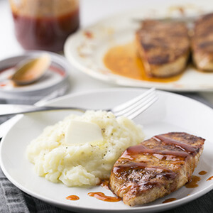 This seasoned skillet pork chops are come together in less than half an hour for a delicious weeknight dinner! The tangy sauce is perfect on the side. | Recipe from Chattavore.com